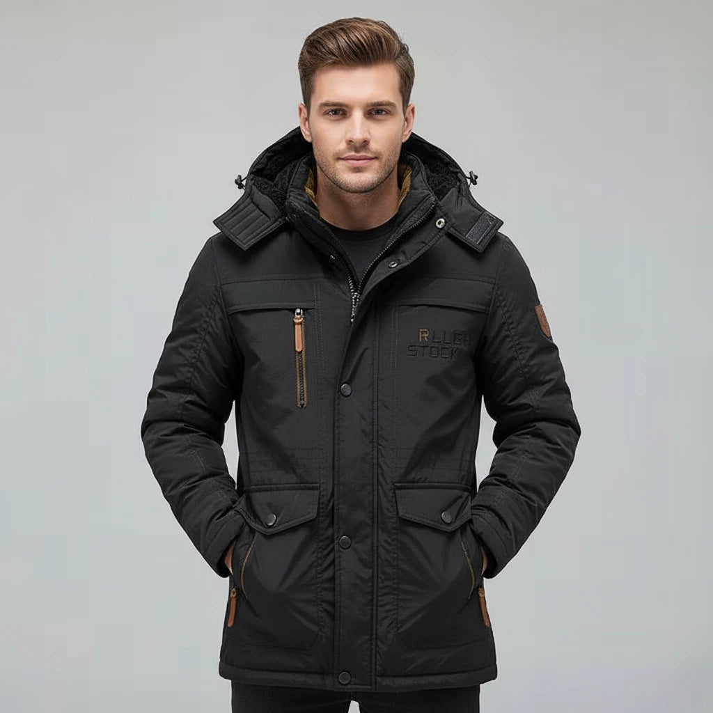 Man wearing a black winter jacket on a gray background