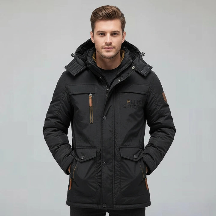 Man wearing a black winter jacket on a gray background