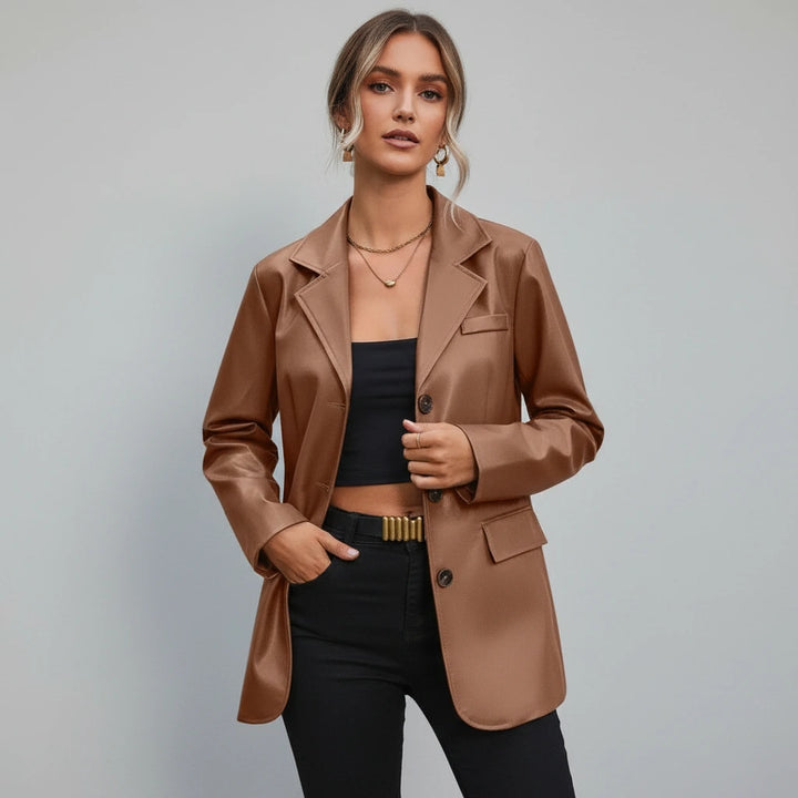 Woman wearing a brown blazer over a black top and pants on a gray background