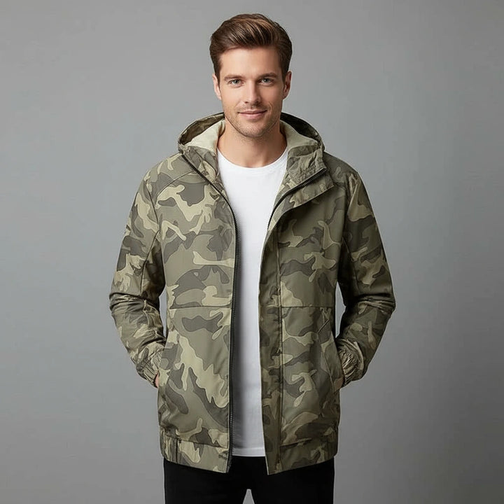 Man wearing a camouflage jacket on a gray background