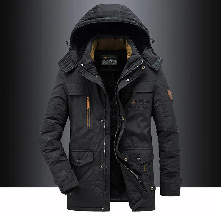 Black winter jacket with a hood on a dark background